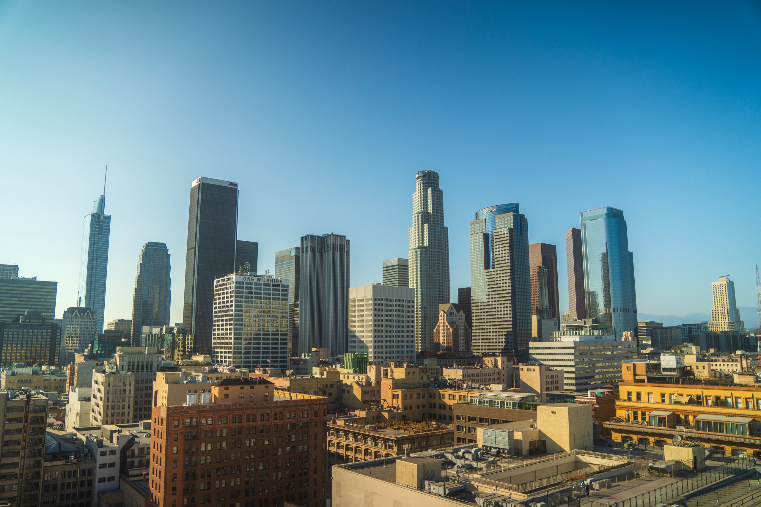 Downtown Los Angeles skyline against a clear blue sky