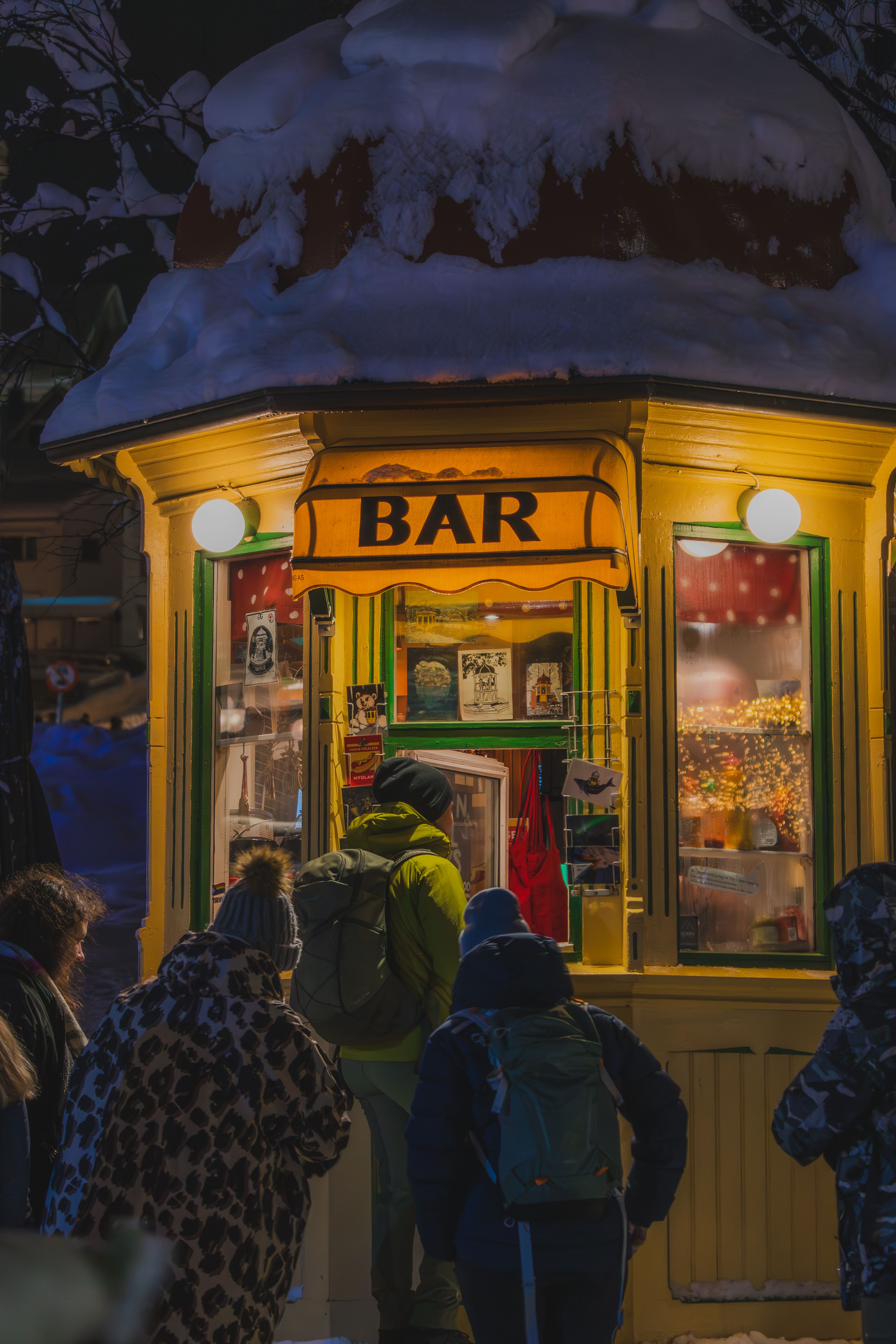 Colorful bar kiosk glowing in the winter night
