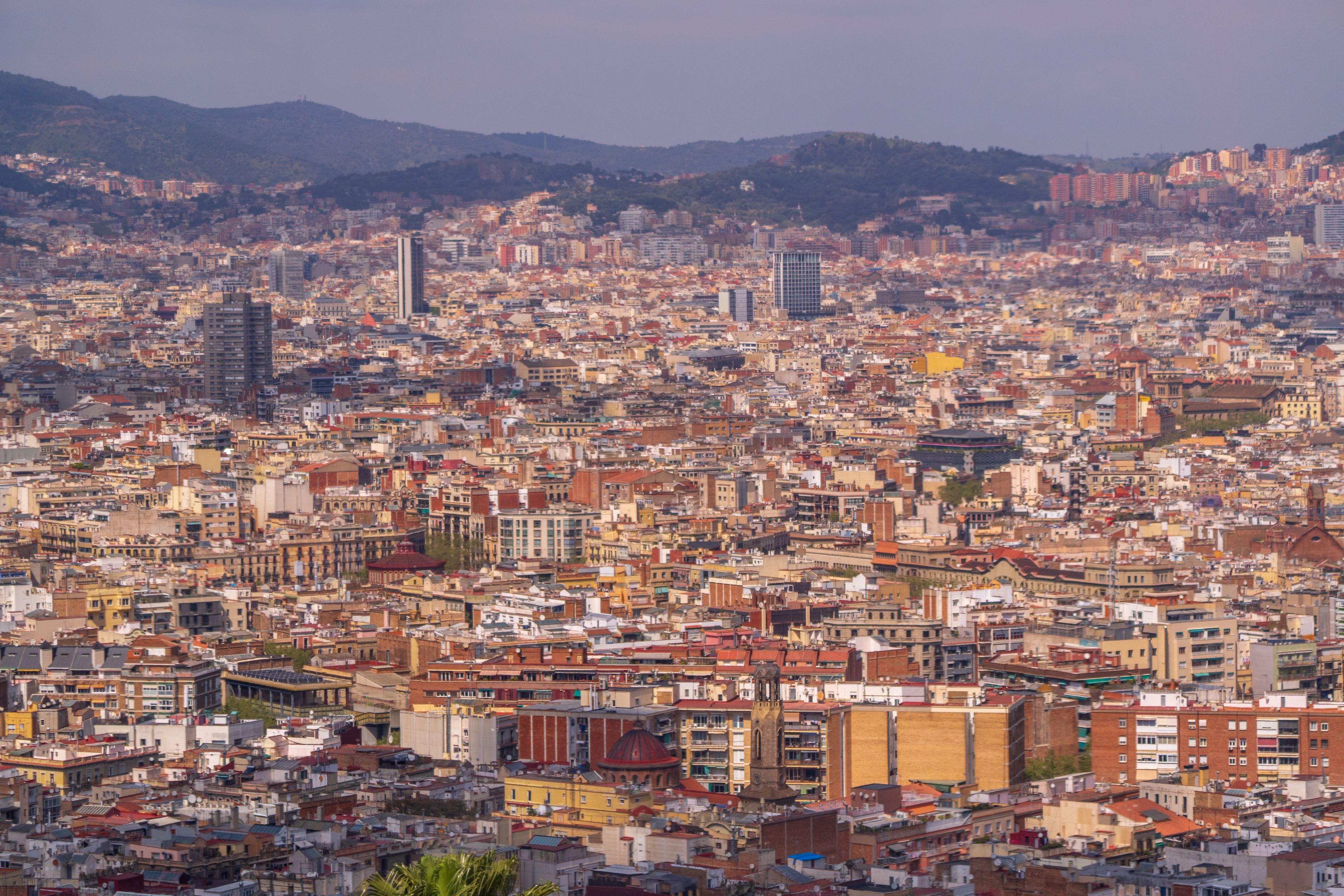 Barcelona's dense cityscape stretching toward the hills at golden hour