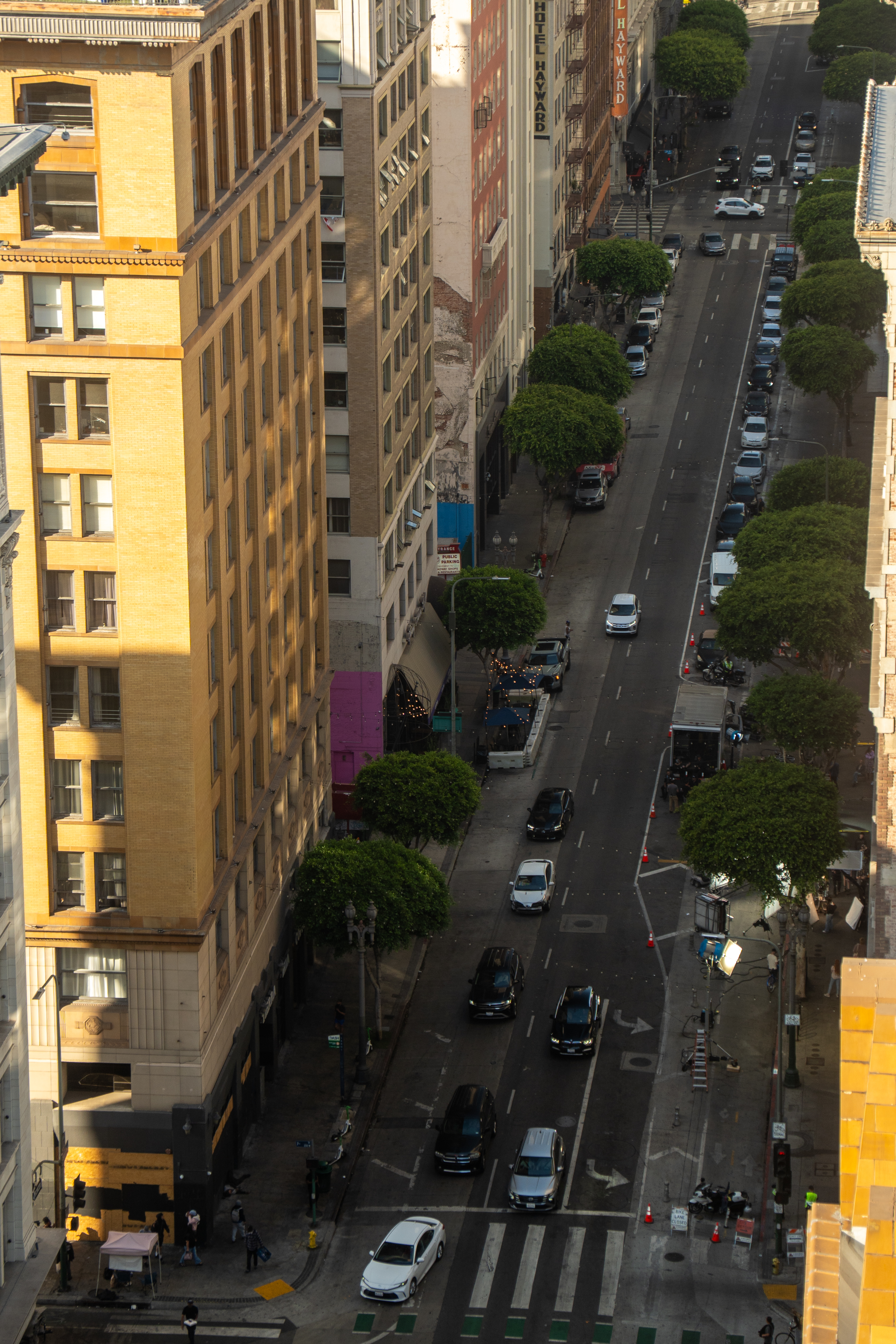 Bird's-eye view of a downtown Los Angeles street bathed in golden light